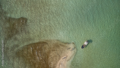 фотографія Aerial drone view of a fly fisherman wading the crystal-clear tropical flats of Kiritimati (Christmas Island), Kiribati
