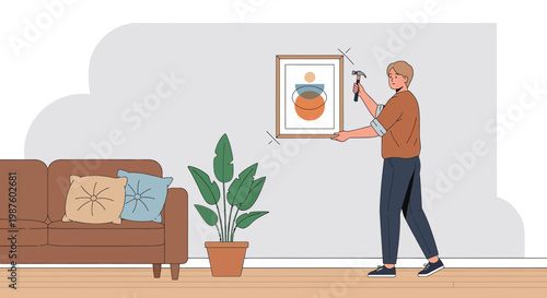 Man hanging abstract art on wall, home decor, interior design, DIY home improvement