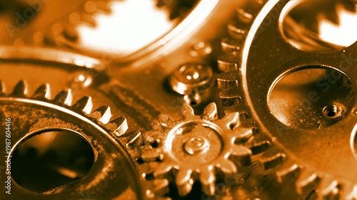 High-quality footage of warm golden-toned rotating gears. Ideal for business success, financial growth, and prestige engineering.
