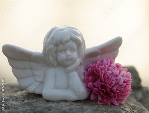 angel with a flower. Decoration. Angel. Photo. Background. 