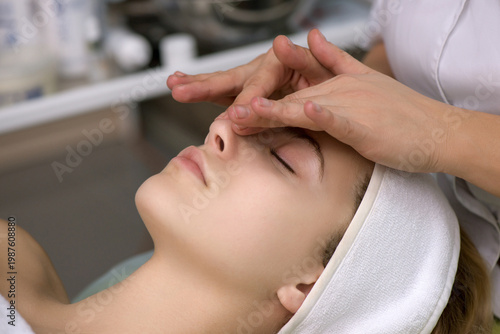 Face massage.  Close-up of young woman getting spa massage treatment at beauty spa salon.