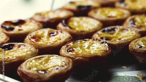 Pasteis and Pastel de nata, traditional Portuguese egg custard tart pasty cakes, dessert Pasteis de nata with different pastry in the cafe, bakery display window, Pastel de belem, Lisbon, Portugal