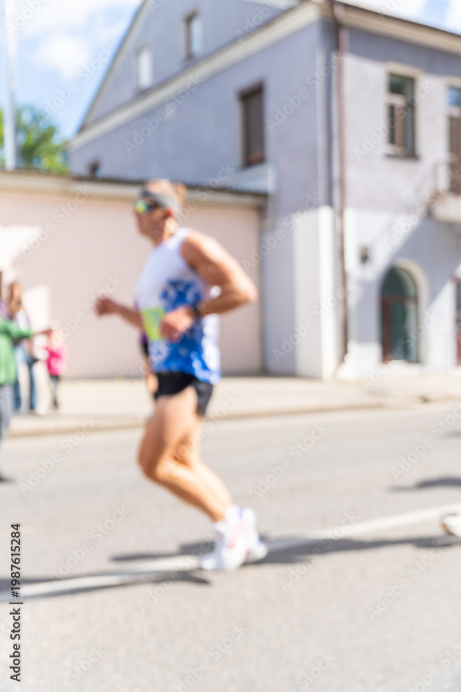 Obraz premium Blurry action shot of a male runner in sportswear