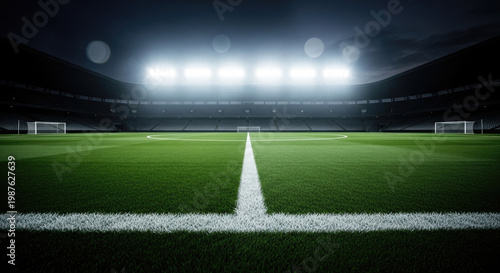 Illuminated soccer stadium with green grass field and white lines under a dark sky creating a dramatic sports scene