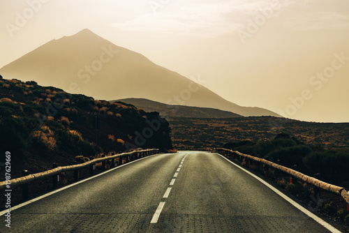 Beautiful view of the straight road leading into the distance to the Teide volcano at sunset.