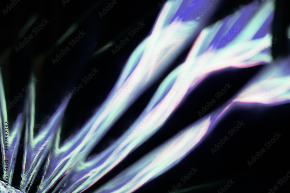 Fototapeta premium Soft focus abstract image of flowing white and purple light shapes on black