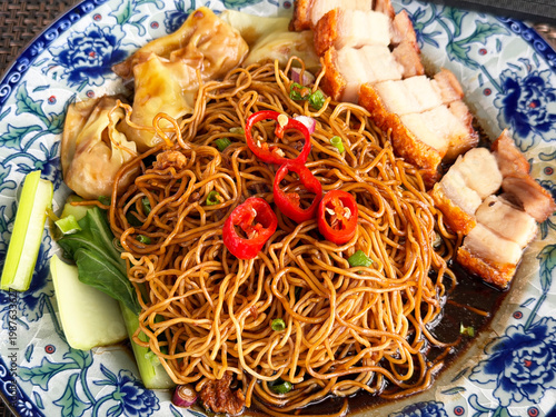 Malaysian Chinese crispy roast pork belly Siew Bak, with wantons, noodles and red chilis