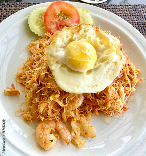Malaysian fried `mee Hoon noodles with a fried egg