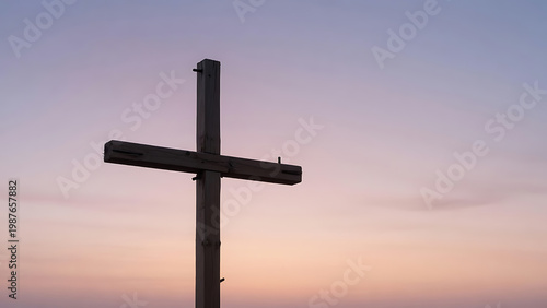 Large Wooden Cross Silhouette Against A Soft Pastel Sunset Sky