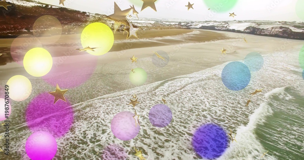 Fototapeta premium Showing shoreline and surf rolling onto wet sand on beach, bokeh circles and gold stars overlaying