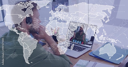 Talking mid-adult wearing green shirt and headset at home office, laptop showing child, map overlay