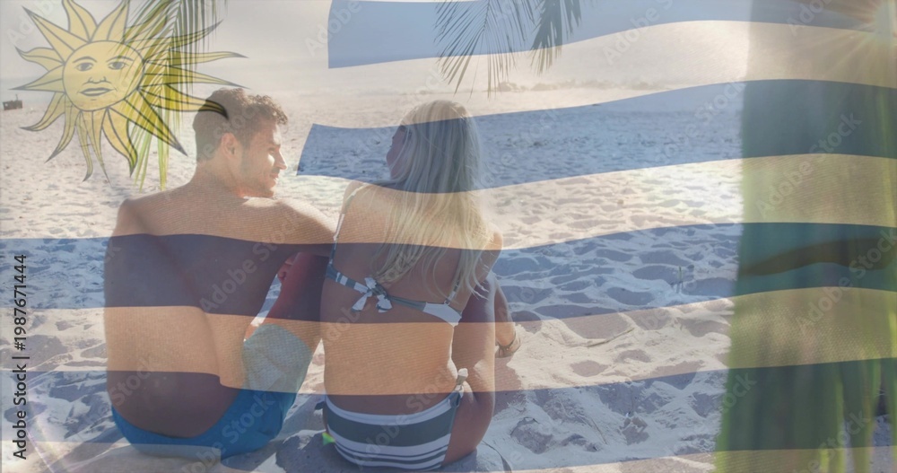 Obraz premium Sitting couple wearing swimwear facing ocean on sand, with blue-white stripes, yellow sun emblem