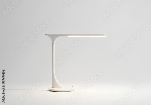 Modern minimalist desk lamp illuminating a bright workspace environment.