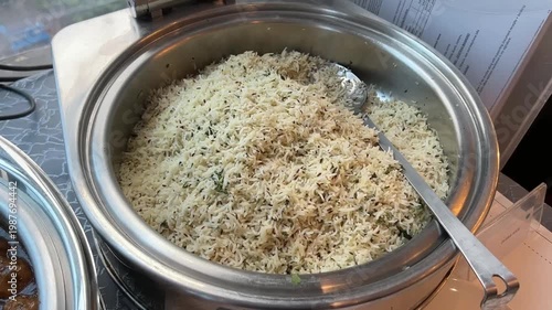 Long-grain basmati rice tempered with roasted cumin seeds and fresh coriander, served at a traditional festive event in India.
