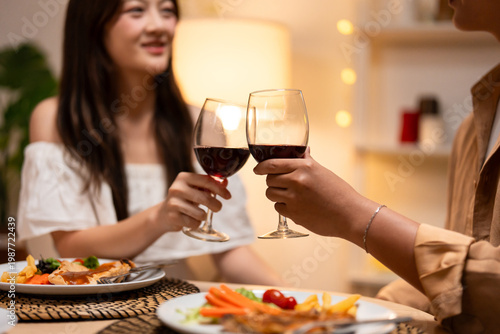 Asian young couple clinking glass of wine and drink on valentine's day. 