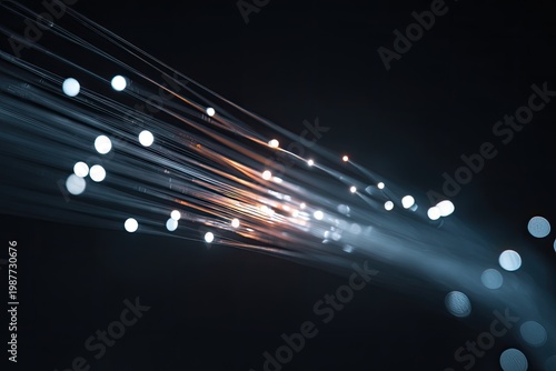 Streaks of light and bokeh dots emanate from a dark background