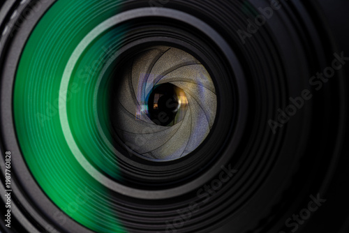 Bild auf Leinwand Close up of camera lens aperture blades with green lens flare reflection,Macro,Extreme close-up macro shot of a professional camera lens showing the mechanical aperture diaphragm blades and internal