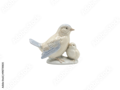 Small vintage porcelain figurine of a mother bird and her baby chick with light blue wings and a smooth glazed finish standing isolated transparent background image