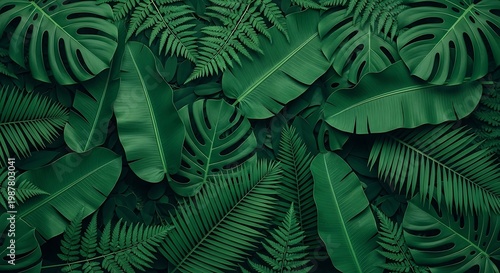 A lush arrangement of various green tropical leaves and ferns in a dense jungle foliage setting with different textures and shapes