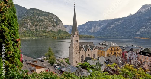 Scenic Hallstatt village with church and lake in Austrian Alps