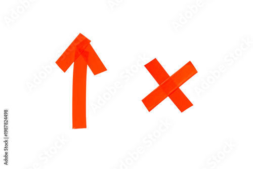 Adhesive red tape creating a cross and an upward arrow, representing choice, decision, direction, and evaluation