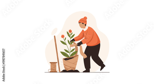 Skilled gardener wearing a warm orange knit hat and sweater meticulously protects a blooming potted plant by wrapping the base with textured burlap.
