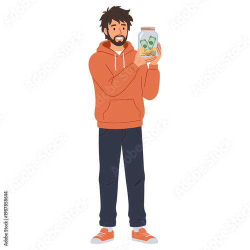 A man holds up a jar of money while standing and smiling