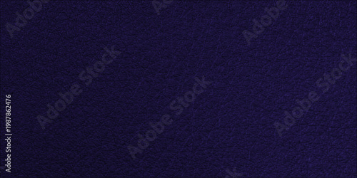 A dark blue denim fabric texture with a rough cotton material pattern creates a textured textile background on a grunge indigo canvas surface