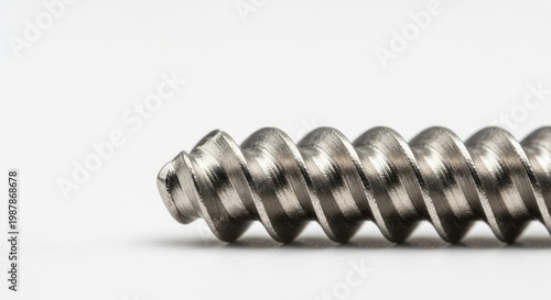 Close-up detailed macro photograph of a small, intricate helical screw thread
