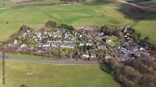 Drone flyover of the historic village of Eddleston in the Scottish Borders featuring traditional stone cottages and scenic countryside views