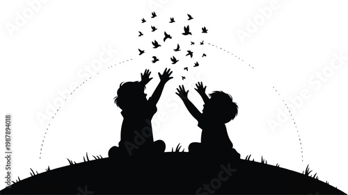 silhouette of two children sitting on a hill releasing birds into the air freely