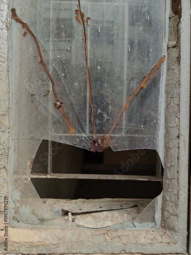 Broken Glass Window with Cracked Frame and Peeling Paint