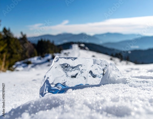 Close-up of a Clear Ice Block on a Snowy Mountain Ridge with a Scenic Blue Sky and Alpine Horizon