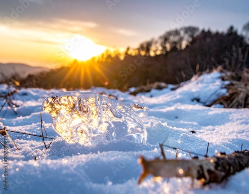 Close-up of a Clear Ice Block on a Snowy Mountain Ridge with a Scenic Blue Sky and Alpine Horizon