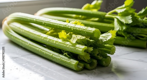Fresh celery stalks on counter.