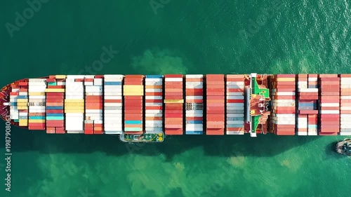 Aerial drone top view video of fully loaded container ship cruising open ocean sea for logistics import export, shipping, or transportation