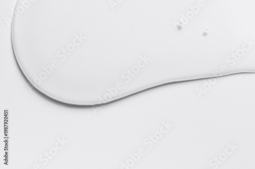 Cosmetic product in the form of a transparent drop. A moisturizing gel or serum for the face. Copy space