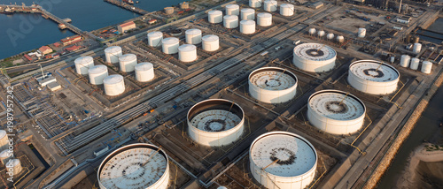 Aerial view of oil refinery, storage tanks, and adjacent port, showcasing energy infrastructure, petroleum processing, and industrial landscape.