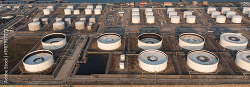 Aerial view of oil refinery, storage tanks, and adjacent port, showcasing energy infrastructure, petroleum processing, and industrial landscape.