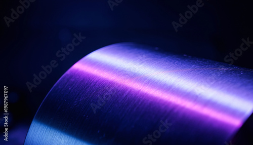Close-up of a metallic cylindrical object with colorful lighting effects.
