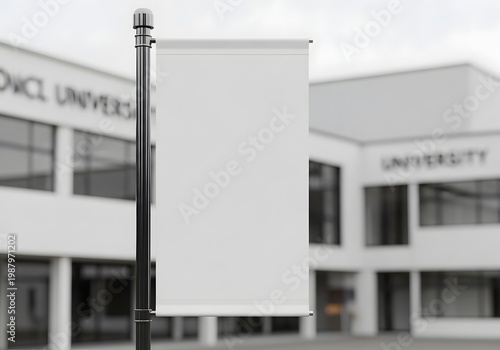 Vertical blank white banner mockup on a chrome pole positioned in front of a defocused modern university building campus facade. Detailed 3D rendering for educational signage.