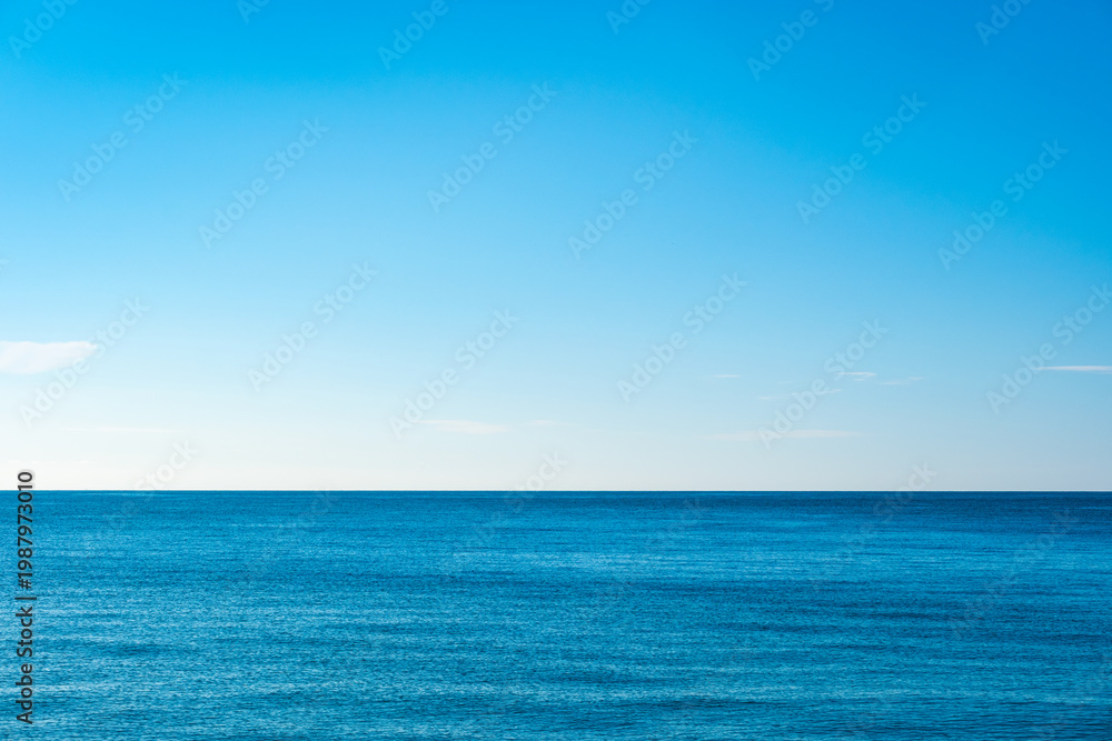 Fototapeta premium A bright, clear blue sky meets a glowing white horizon, suggesting a serene, open, and with sunlight of beautiful cloudy sky. landscape or abstract background 