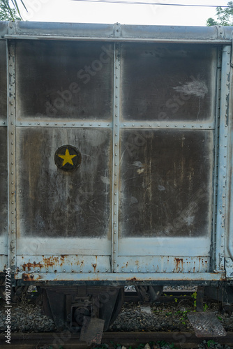Old weathered train bogy cargo container with rust and scratches, showing aged metal textures and industrial details, perfect for concepts of history, transportation, and decay.