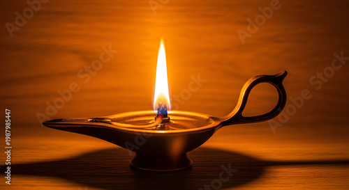 Vintage oil lamp with burning flame on wooden background, ancient brass aladdin lamp glowing in dark, traditional middle eastern light source