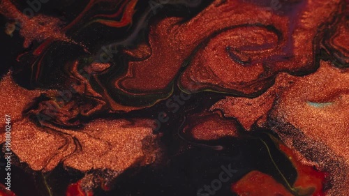 Shiny copper metallic paint on a black background. Fluid art acrylic pouring macro texture
