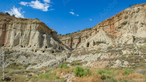 exterior of old troglodyte dwellings  in the Bardenas desert in Spain  under blue sky