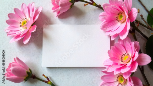 Invitation card mockup design with pink gerbera flowers, gift certificate, top view. Mother's day or women's day greeting card template, paper blank business card. Gray background sunlight shadow.