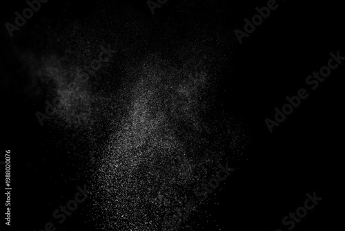 Water spray particles and mist on black background