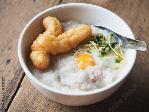 Bild auf Leinwand congee with deep fried Patongko bread stick dough, boiled egg, minced pork ball,