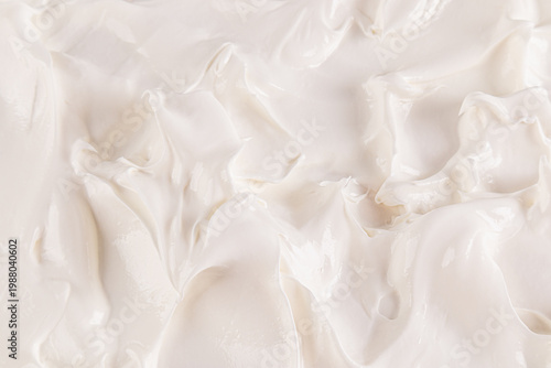 The perfect texture of white buttercream with a homogeneous dense mass. Beautiful curls of cream. vanilla cream. top view. selective focus.